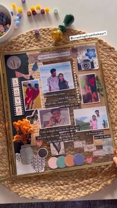 a person holding up a scrapbook with pictures and other things on top of it