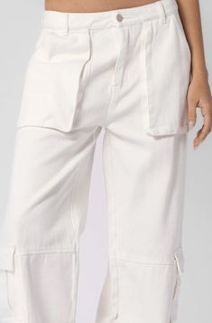 Final Sale - Get it before it's gone! Step out in style in the Jess White Low Rise Denim Cargo Pants! Woven off-white fabric forms these cute low-rise cargo pants with front cargo pockets. Six-pocket construction, banded waist with belt loops, and front pockets. Pair with a cropped tee and your buckle sandals for a fun look. DETAILS & FIT Low-Waisted Fit. Cotton. Machine wash cold. Imported. Cream Straight Leg Cargo Pants With Patch Pockets, Mid-rise Beige Cotton Cargo Jeans, Cream Straight Leg Utility Cargo Pants, Cream Straight Leg Utility Pants, Cream Utility Cargo Pants With Pockets, Cream Utility Cargo Pants, Cream Wide Leg Cargo Pants, White Cotton Pants With Cargo Pockets, Utility Cream Cargo Pants