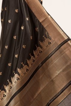 Beautiful Black Katan Silk Banarasi Saree, meticulously crafted with a lustrous gold zari Temple border and exquisitely detailed pallu. Adorned with intricate zari bootas across its body, this saree radiates with sophistication. Feel the luxury with its soft-to-touch fabric, perfect for making a graceful statement at any festivity. Traditional Gold Dupatta For Ceremonial Occasions, Luxury Dupatta For Festivals, Gold Traditional Wear With Self Design For Transitional Season, Gold Self-design Traditional Wear For Transitional Season, Gold Chanderi Traditional Wear For Ceremonial Occasions, Gold Traditional Wear With Meenakari For Transitional Season, Gold Dupatta For Festive Traditional Ceremonies, Luxury Wedding Dupatta With Traditional Patterns, Gold Katan Silk Traditional Wear With Zari Weaving