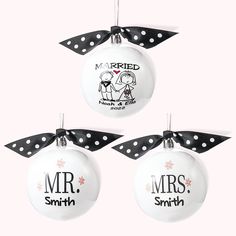 three ornaments with black and white polka dot ribbon hanging from the top of each ornament