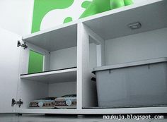 a white shelf with some food in it and a green cow painted on the wall