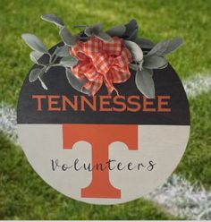 a tennessee volunteers sign on the side of a football field with an orange and white bow