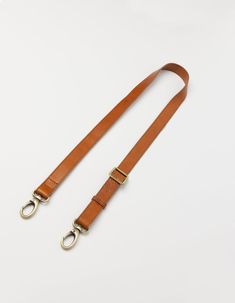 The details on this strap are made from our Stromboli leather which has a slightly textured appearance. Shorter than our regular webbing straps, with a maximum length of 115cm, this strap features our brass dog hooks and can be used on any O My Bag. Our personal favorite is the Beck's Bum Bag x leather strap combo. Minimum length: 67cm and Maximum length: 115cm. OMB-leatherbumbagstrapbs Rectangular Leather Bag Strap With Leather Handles, Rectangular Leather Bag Strap With Handles, Business Leather Bag Strap, Classic Dark Tan Shoulder Bag With Adjustable Strap, Classic Bag Strap For Everyday Use, Classic Adjustable Bag Strap For Everyday Use, Classic Leather Crossbody Bag Strap, Classic Everyday Adjustable Bag Strap, Leather Adjustable Strap For Business Bags