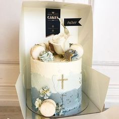 a cake in a box decorated with flowers and a cross on the top that says cakes aster