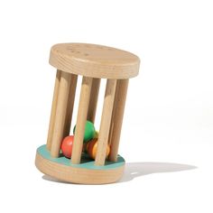 a small wooden toy with balls in it's holder on a white background,