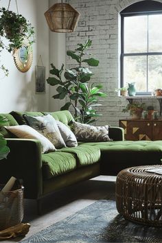 a living room filled with furniture and plants