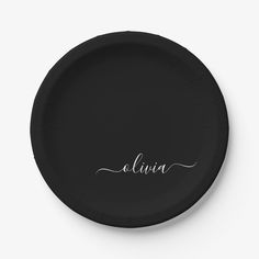 a black paper plate with the word aluna written in cursive writing on it