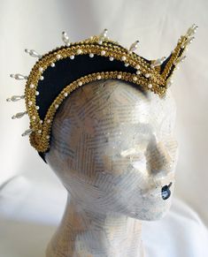 This royal Tudors inspired attifet headdress will make an excellent addition to your historical costume. It is covered with black silk shantung and embellished with golden braided trimming all around the edges.This unique piece wouldn't be complete without all those wonderful pearl bead details that add some royal flair to it's elegance. Choose between only pearl decoration or a combination of pearl beads and small red crystals to add just a pop of color. The headpiece is very light and comforta Traditional Fitted Headpiece For Costume, Handmade Tall Crown Headpiece For Costume Party, Elegant Tall Crown Headpieces For Costume Party, Handmade Tall Crown For Costume Party, Handmade Fitted High Crown Mini Hats, Handmade Fitted Mini Hat With High Crown, Traditional Carnival Costume Headpieces, Fitted Tall Crown Costume Hats, Fitted Costume Hat With Tall Crown