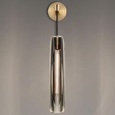 a light that is hanging from the ceiling in a room with grey walls and flooring