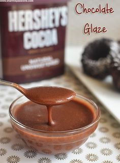 chocolate glaze in a glass bowl with a spoon next to it and a box of hershey's cookies on the side