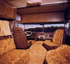 the inside of an rv with couches, chairs and curtains on it's sides