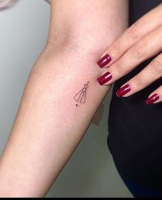 a woman's arm with a small tattoo on the left side of her arm