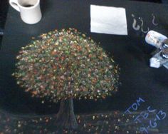 a table with a tree on it and some writing on the table next to it