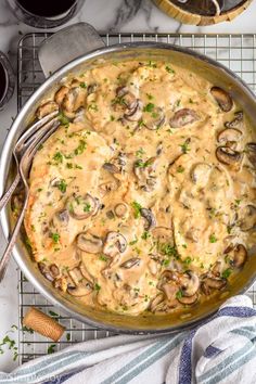 a skillet filled with mushroom gravy on top of a table