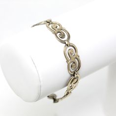 "Lovely vintage circa 1940s era 14k gold filled sterling silver bracelet! This classic bracelet is comprised of unique scroll style panels, and secures with a fold over clasp. A stylish piece of signed vintage jewelry! *Sale - price reduced from $135 to $125 USD.  ERA - Circa 1940s - Retro METAL / MATERIAL - 14k gold filled on sterling silver  MARKINGS / HISTORY - Bracelet is marked \"SYMMETALIC STERLING+14k\" Symmetalic was a trade name of the W. E. Richards Company of North Attleboro, Massachusetts, which was first used in the mid 1930s until at least the 1940s. W. E. Richards Co was founded in the early 1900s. CONDITION - Good vintage condition. Gold filled & sterling silver has been professionally polished & cleaned. Age appropriate patina & wear remains. Amazing vintage bracelet!  MEA Vintage White Gold Jewelry With Polished Finish, Mid-century Polished Finish Jewelry For Anniversary, Antique Polished Bracelet Jewelry, Antique Metal Jewelry With Polished Finish, Classic Silver-colored Brass Bracelets, Classic Silver Brass Bracelets, Vintage Hallmarked Gold Bracelet For Anniversary, Retro Brass Jewelry For Formal Occasions, Vintage Engraved White Gold Bracelets