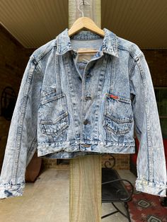 This vintage Jordache acid wash denim jacket has been lovingly embroidered with florals on the back and on the right sleeve. It would be a perfect denim jacket for a wedding day look, or for everyday wear.  It has authentic distressing from its former life, and has lots of years left in it. This jacket is slightly cropped, and hits at the hip for most body types. Vintage Dark Wash Denim Vest For Spring, Fitted Faded Spring Outerwear, Fitted Acid Wash Denim Jacket For Spring, Fitted Faded Denim Jacket For Spring, Vintage Acid Wash Denim Jacket For Spring, Long Sleeve Bleached Denim Jacket For Spring, Spring Stonewashed Denim Blue Denim Jacket, Vintage Denim Vest With Pockets For Spring, Vintage Denim Jacket With Pockets For Spring