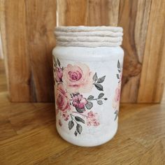 a white vase with pink flowers painted on it