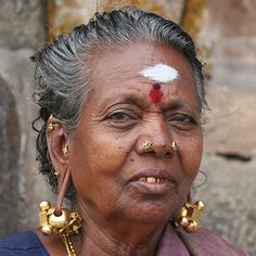 an old woman with some piercings on her forehead