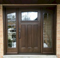 a brown front door with two sidelights and glass panels on the top half of it