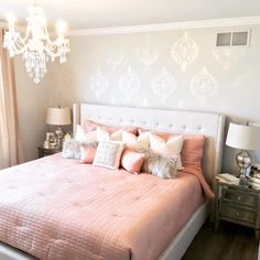 a bedroom with a bed, nightstand and chandelier