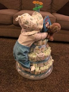 a teddy bear sitting on top of a stack of diapers