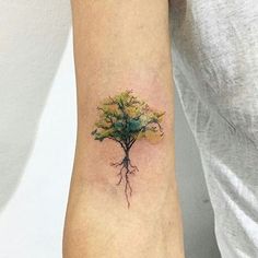 a small tree tattoo on the left arm