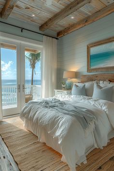 a large bed sitting in a bedroom next to a sliding glass door with an ocean view