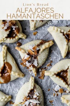 some food is sitting on top of a sheet of wax paper with the words lion's bread alfajores hamantaaschen