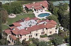 an aerial view of a mansion with a swimming pool