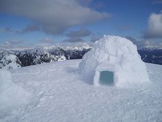 an igloose on top of a mountain covered in snow