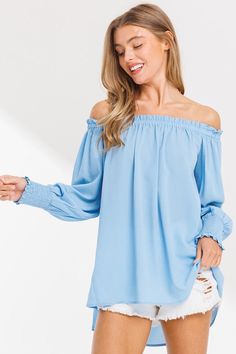 Feeling blue has never looked so good, when you wear our Feeling Blue Off Shoulder Top! This off shoulder top in a dreamy baby blue hue, is the perfect effortless addition to your wardrobe. It's loose fitting design, long sleeves with smocked cuffs, and high-low hem provide both style and comfort. Say goodbye to fashion blues with this trendy top! Styling Tip: Cut offs, boots, and a hat make this cutie concert approved, but you can also pair it with some white skinnies for a day out with friends Blue Off-shoulder Top For Fall, Blue Top With Smocked Bodice For Brunch, Blue Long Sleeve Off-shoulder Top For Spring, Light Blue Smocked Back Top For Spring, Blue Off-shoulder Tops For Spring, Trendy Blue Flowy Blouse, Blue Long Sleeve Off-shoulder Top For Summer, Summer Billowy Blue Top, Casual Off-shoulder Top With Smocked Back