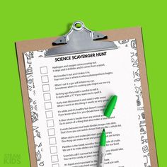 a clipboard with a green marker on it and the words at - home science scavenger hunt