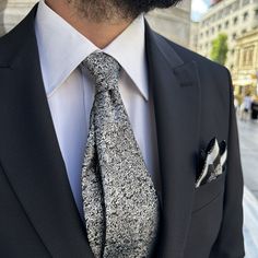 Product Description with Qualifications Crafted with precision and care, our handmade tie and pocket square set is designed for the discerning customer who values both style and quality. The tie features a subtle yet striking silver static noise pattern on luxurious black silk fabric, perfectly complemented by a matching pocket square with thick-framed, overlocked edges. This 7 cm wide tie exudes elegance, making it suitable for all your special occasions or as an unforgettable gift. Elegant Des Elegant Ties With Pocket Square For Father's Day, Classic Silver Tie For Groom, Elegant Black Tie Suits With Pocket Square, Elegant Black Tie Suit With Pocket Square, Elegant Black Tie Pocket Square, Classic Ties With Pocket Square For Gift, Classic Ties With Pocket Square As Gift, Classic Pocket Square For Gift, Black Tie Pocket Square For Father's Day