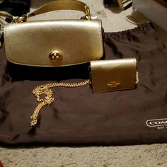 Set Brown And Gold Coach Bag And Chain Cross Body Gold Chain Shoulder Bag For Travel, Elegant Gold Wallet On Chain With Chain Strap, Elegant Gold Wallet On Chain, Chic Gold Wallet On Chain With Branded Hardware, Gold Shoulder Bag With Chain For Travel, Chic Gold Wallet On Chain Gift, Chic Gold Wallet On Chain As Gift, Elegant Gold Wallet On Chain For Gift, Classic Gold Wallet On Chain For Travel