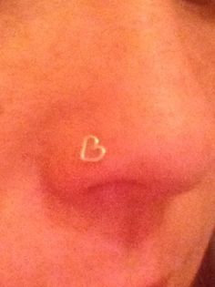 a woman's nose with the word love written on it and a heart in the middle