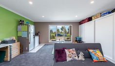 a living room filled with furniture and green walls