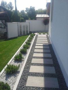 an empty backyard with stone steps leading up to the grass and bushes on either side