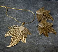 Bridesmaid Jewelry Set, Leaf Jewelry Set, Earrings and Necklace Gold Leaf, Bridesmaid Gift, Gold Leaf Wedding Jewelry This outstanding set would be beautiful for a bridal party, prom, or special occasion. A gorgeous set of gold leaf necklace and earrings. This fashionably chic leaf jewelry set is very delicate, Classy, elegant, and light-weighted. It will be the perfect gift for someone you love. The 22 K gold plated leaf pendant is measured approximately 53 x 52 mm in size and the stud leaf ear Gold Bridesmaid Necklace, Gold Leaf Jewelry, Twig Jewelry, Jewelry Set Gold, Ceramic Pendants, Unique Gold Jewelry Designs, Gold Leaf Necklace, Bridesmaid Earrings Gold, Gold Bridesmaids