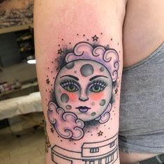 a woman's arm with a clock and stars on it, in the shape of a moon