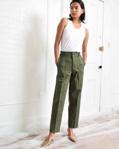 "Vintage army green utility slacks. High waist. Straight leg. Two side pockets. Two back pockets. Zipper fly. Fabric: 50% Cotton, 50% Polyester See dropdown menu for available sizes. Inseam varies between 29\" to 31\". Waist: 25.5\" Hips: 38\" Rise: 12\" Waist: 27\" Hips: 38\" Rise: 12\" Waist: 28\" Hips: 38\" Rise: 12\" Excellent vintage condition. Please note that each pair has unique distressing and subtle signs of wear that sometimes include small stains or minor mended areas. Photo represen Army Trousers, Fatigue Pants, Army Fatigue, Office Pants, Army Green, Business Casual, Capri Pants, High Waist, Straight Leg