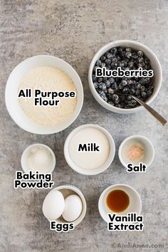 ingredients for blueberry muffins laid out in bowls on a gray background with the words all purpose flour