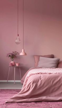 a bed with pink sheets and pillows in a room that has been painted pale pink