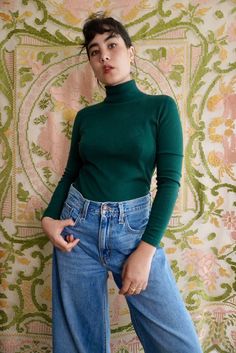 "Forest green turtleneck sweater by Modern Ms. This knit is lightweight and stretchy, semi-sheer when pulled taut. No fiber content labels, based on texture and appearance it is most likely acrylic. Pull over style with no closures or fastenings.  Size XS-S. 32\" chest, 30\" waist, 22.5\" long. 1970's." Spring Fine Knit Turtleneck With Funnel Neck, Spring Turtleneck Sweater, Green High Neck Sweater With Stretch, Green High Neck Stretch Sweater, Green Stretch High Neck Sweater, Green Funnel Neck Sweater For Fall, Fitted Knit Turtleneck In Solid Color, Fitted Solid Knit Turtleneck, Fitted Solid Color Knit Turtleneck