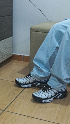 a person sitting on a couch with their feet propped up