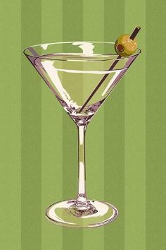 a martini glass with an olive garnish on the rim and green striped background