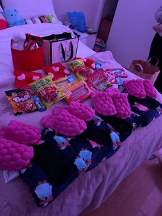 the bed is covered with candy and other items