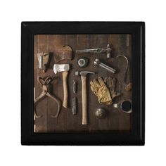 an old tool is displayed in a shadow box on a wooden table with other tools