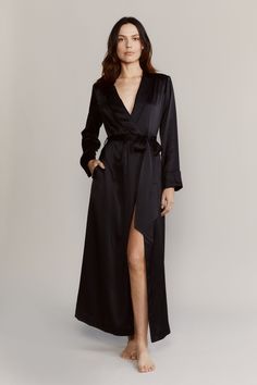 The Matador robe has an elegant elongated silhouette that drapes effortlessly. Made with 19mm silk satin and accented with tonal piping. Use the detachable belt to cinch the waist. Slip it on over the matching pajamas. 100% Silk Satin Cold water wash / hang dry Slim fitting Shawl collar Self-belted wrap closure with button and internal self-tie Long sleeve with vented cuff Model is 175cm / 5'9" and is wearing a Small Elegant Wrap Robe With Tie Waist, Elegant Long Sleepwear For Evening, Fitted Silk Robe For Loungewear, Silk Fitted Robe For Loungewear, Elegant Silk Robe For Loungewear, Chic Satin Robe For Formal Occasions, Fitted Satin Robe For Loungewear, Formal Long Silk Robe, Chic Satin Formal Robe