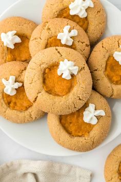 some cookies are on a plate with white frosting