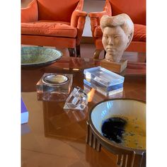 a living room filled with furniture and a busturine on top of a coffee table